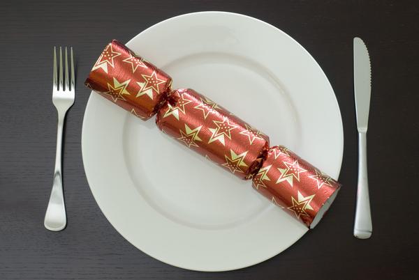 christmas place setting a modern christmas dinner table place setting with a cracker on a plate